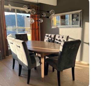 a dining room table with chairs and a wooden table at Marits residense in Kongsberg +4 photos