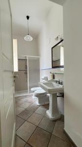 a bathroom with a sink and a toilet and a mirror at Chicca's Apartments Gallipoli in Gallipoli +50 photos