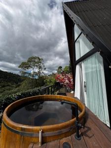 a hot tub on the deck of a house at Cabana Veneza in Santa Teresa