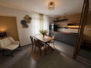 a kitchen and dining room with a table and chairs at Ada&Cris Apartament in Klotten