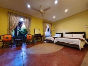 a bedroom with a bed and a table and chairs at Golden Snapper Guest House in Yan +31 photos