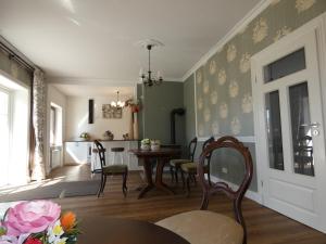 a living room with a table and chairs and a dining room at fewo1846 - Romanze - idyllische Wohnung mit Garten im Grünen in Gelting