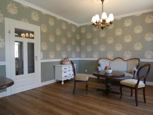a living room with a table and chairs and a chandelier at fewo1846 - Romanze - idyllische Wohnung mit Garten im Grünen in Gelting