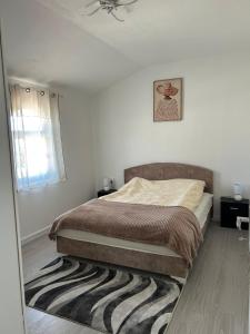 a bedroom with a bed and a zebra rug at E&L Apartments in Kovačina