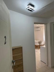 a hallway with a room with a ceiling fan at E&L Apartments in Kovačina