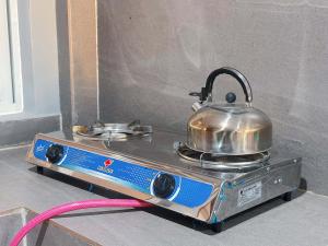 a tea kettle sitting on top of a stove at Pineda Villa in Puerto Princesa City +16 photos