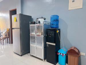 a room with two refrigerators sitting next to a wall at Pineda Villa in Puerto Princesa City