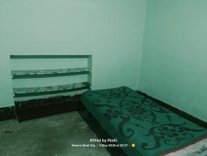 a small room with a bed in the corner at Quarter 2355 in Bokāro
