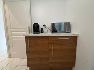 a microwave sitting on a counter next to a door at Studio T1 in Dax