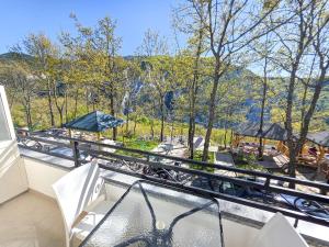 a balcony with a hot tub and a view of trees at Hotel Restaurant Ujimira in Radomirë +34 photos