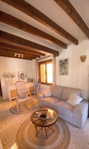 a living room with a couch and a table at Casa el Montcel, a unique chalet with roofterrace and shared pool in Denia