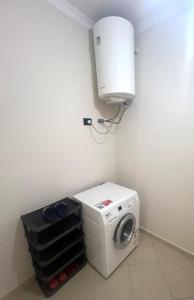 a washer and dryer in a corner of a room at B2 Apartment 4 in Kashari +2 photos