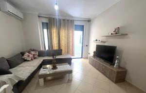 a living room with a couch and a tv at B2 Apartment 4 in Kashari