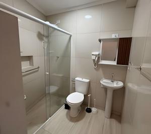 a bathroom with a toilet and a shower and a sink at Maryah Prime Studio Hotel Extrema + breakfast in Extrema +46 photos