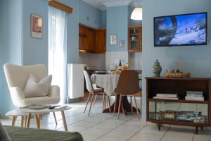 a living room with a table and chairs at Casa di Mare Air-bnb in Nafpaktos +12 photos