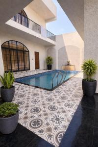 an indoor pool in a building with plants in pots at Luxury private pool villa for families & groups in Ujjain