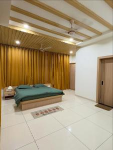a bedroom with a green bed and a curtain at Luxury private pool villa for families & groups in Ujjain
