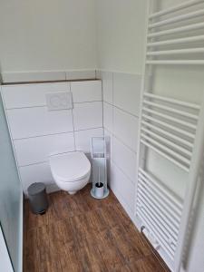 a small bathroom with a toilet and a trash can at Ferienwohnung Bever in Bad Karlshafen +13 photos