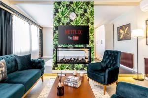 a living room with two blue couches and a fireplace at Bellavia Deluxe Apart in Istanbul