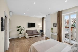 a hotel room with a bed and a couch at Pompei Luxury Suites-Near Ruins in Pompei