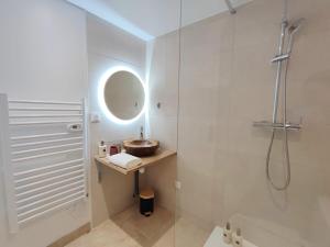 a bathroom with a shower and a sink and a toilet at La Suite Bohème Émeraude in Évreux +5 photos