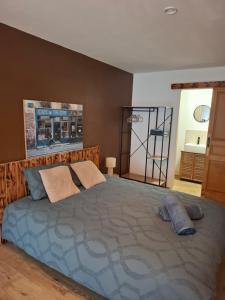 a bedroom with a large bed with two pillows at La parenthèse in Puy-dʼArnac