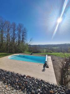 a motorcycle parked next to a swimming pool at La parenthèse in Puy-dʼArnac