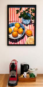 a painting of oranges on a plate on a table at Muckish Hideaway in Crockglass