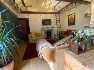 a living room with a couch and a fireplace at Genesis Voorschoten in Voorschoten
