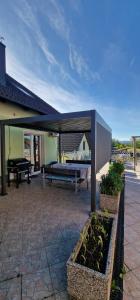 a patio with a pavilion with a bench and a piano at APARTMAN MURKO S-1 in Brest
