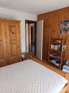 a bedroom with a bed and a book shelf at Le Bochate in La Celle-sous-Gouzon