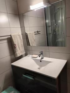 a bathroom with a white sink and a mirror at Le Bochate in La Celle-sous-Gouzon
