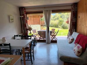 a living room with a couch and a table at Le Bochate in La Celle-sous-Gouzon