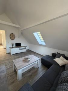 a living room with a couch and a coffee table at Wohnung Epprechtstein Seeperle Weißenstadt in Weißenstadt