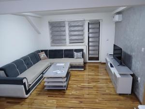 a living room with a couch and a table at Apartman Danica in Foča