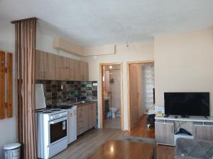 a small kitchen with a stove and a tv at Apartman Danica in Foča