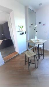 a table and chairs in a room with a bed at LIntemporel in Saint-Sornin +18 photos