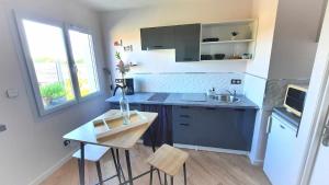 a small kitchen with a table and a sink at LIntemporel in Saint-Sornin