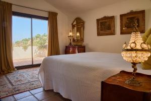 a bedroom with a white bed and a large window at Villa Camilla in Comares +102 photos