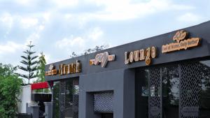 a building with a sign for a restaurant at Mamush Hotel in Ārba Minchʼ