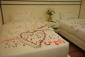 two swans made out of hearts on a bed at Mamush Hotel in Ārba Minchʼ