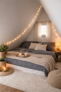 a bedroom with a large bed with lights on it at Hegyi Kuckó Vendégház - Forest Hideaway with Jacuzzi in Biatorbágy