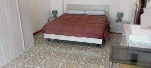 a bedroom with a bed with a red comforter at la casa di LILLY con wi fi in Avellino