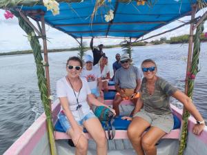 a group of people sitting on a boat on the water at Funzi Beach Resturant in Funzi +1 photo
