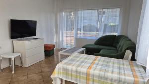 a living room with a couch and a television at Promenada in Koronowo