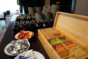 a table with a wooden box and plates and utensils at Westlake Hotels Amsterdam in Amsterdam