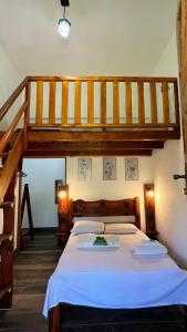 a bedroom with a large bed and a staircase at POUSADA JOSÉ DA ROSA in Santo Antônio do Pinhal +117 photos