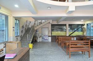 a church with wooden benches and a staircase at Chouhan Hotel in Katihār