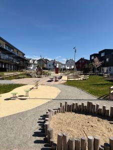 a park with a bunch of picnic tables and benches at Rekkehus i Sandnes in Stavanger