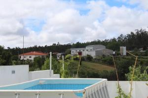 a view from the roof of a house with a swimming pool at Casa Barbeiro in Pombal
